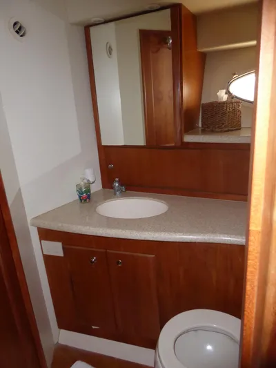 Bee Cee Yacht Photos Pics Bathroom interior of 2000 Silverton 42C yacht, featuring wooden cabinetry and modern fixtures.