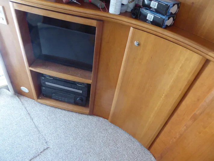 Bee Cee Yacht Photos Pics Wooden cabinet with TV and stereo system in 2000 Silverton 42C Cummins yacht interior.