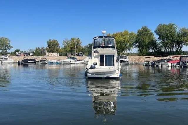  Yacht Photos Pics 2005 Carver 38 Super Sport yacht docked in a serene marina setting.