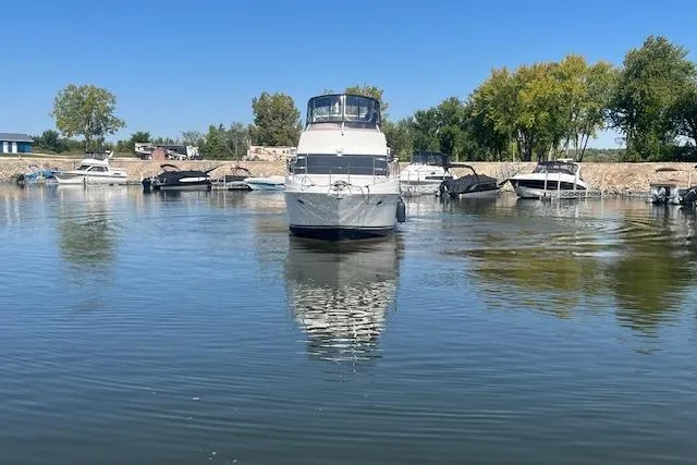  Yacht Photos Pics 2005 Carver 38 Super Sport yacht docked in a serene marina setting.