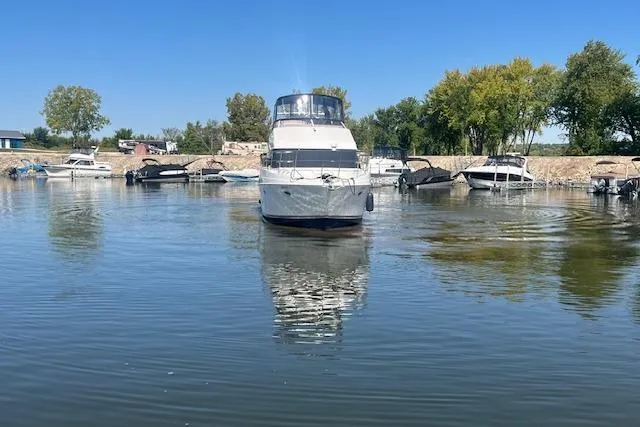  Yacht Photos Pics 2005 Carver 38 Super Sport yacht docked in a serene marina setting.