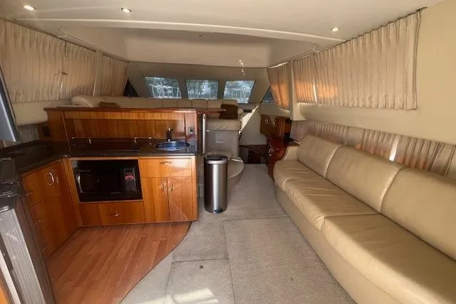  Yacht Photos Pics Interior of 2005 Carver 38 Super Sport yacht with kitchen and seating area.