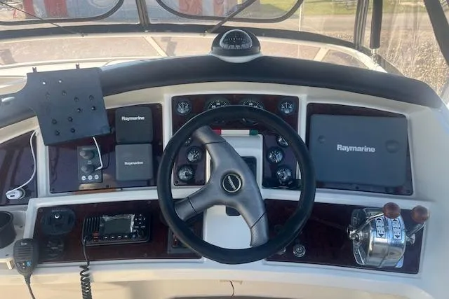  Yacht Photos Pics Helm of 2005 Carver 38 Super Sport with Raymarine navigation equipment and controls.