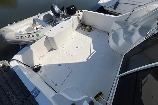  Yacht Photos Pics 2005 Carver 38 Super Sport boat deck with dinghy, docked at marina.