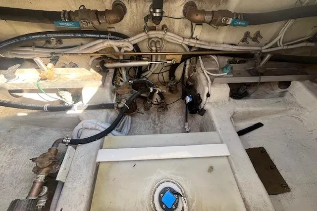  Yacht Photos Pics Engine compartment of a 2005 Carver 38 Super Sport boat, showing pipes and valves.