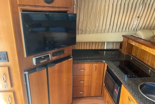  Yacht Photos Pics Interior of 2005 Carver 38 Super Sport yacht with kitchen and entertainment area.