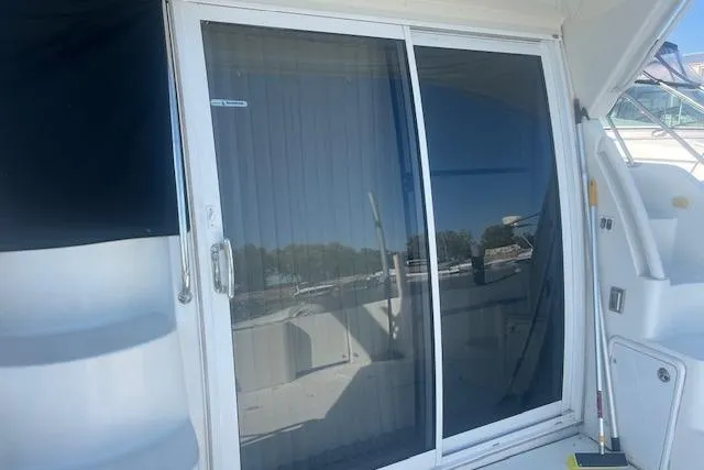  Yacht Photos Pics 2005 Carver 38 Super Sport yacht with sliding glass door and outdoor view.