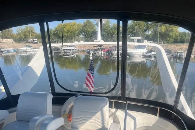  Yacht Photos Pics 2005 Carver 38 Super Sport yacht interior with marina view and American flag.