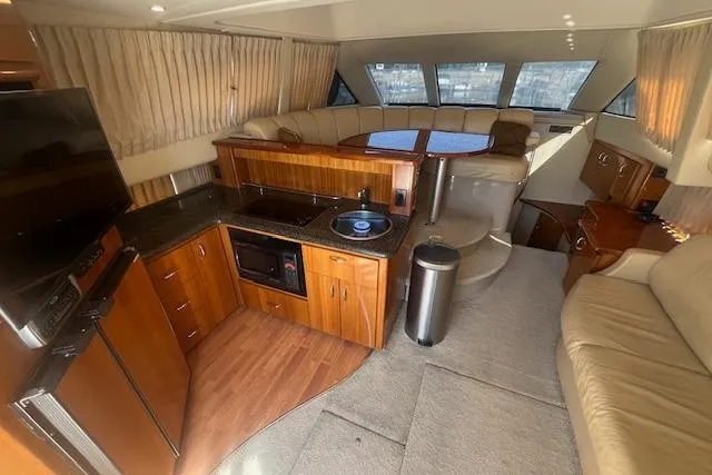  Yacht Photos Pics Luxurious interior of 2005 Carver 38 Super Sport yacht with kitchen and seating area.