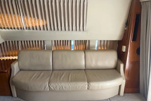  Yacht Photos Pics Interior of 2005 Carver 38 Super Sport yacht with beige leather sofa and curtains.