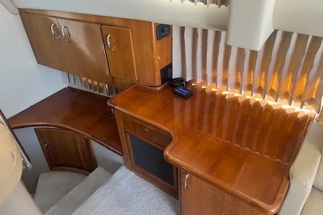  Yacht Photos Pics 2005 Carver 38 Super Sport interior with polished wood cabinetry and countertops.