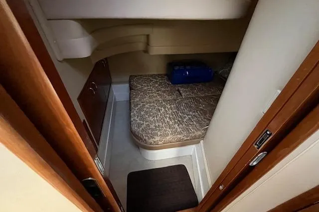  Yacht Photos Pics 2005 Carver 38 Super Sport cabin interior with compact bed and storage.