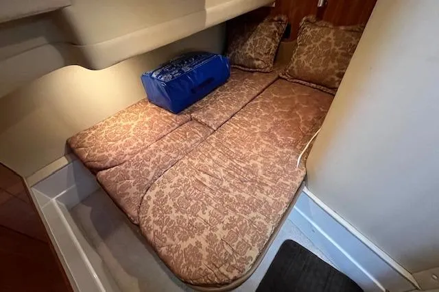  Yacht Photos Pics 2005 Carver 38 Super Sport cabin interior with patterned bedding and cushions.