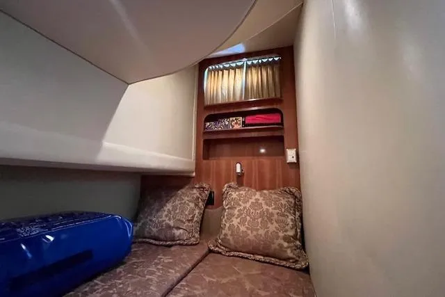  Yacht Photos Pics Interior cabin of 2005 Carver 38 Super Sport with cozy bedding and storage shelves.