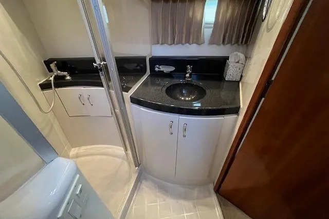  Yacht Photos Pics 2005 Carver 38 Super Sport bathroom with black countertop and shower.