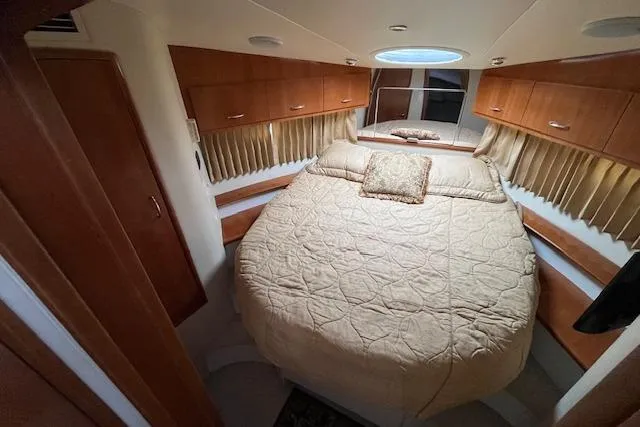  Yacht Photos Pics Interior of 2005 Carver 38 Super Sport yacht with cozy bedroom and elegant wood cabinetry.