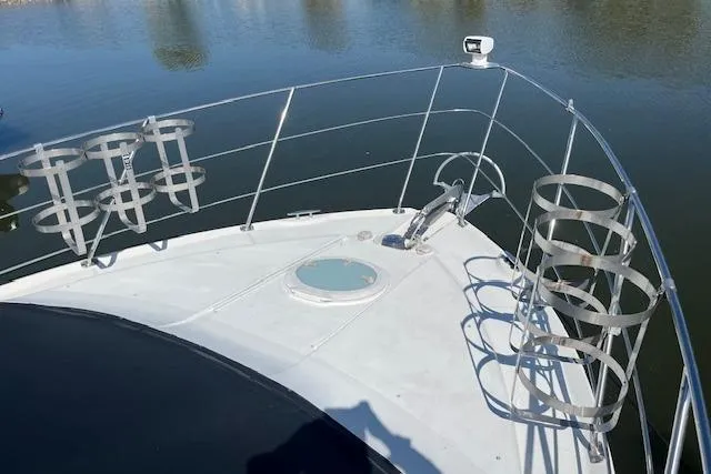  Yacht Photos Pics 2005 Carver 38 Super Sport yacht bow with stainless steel railings and rod holders.