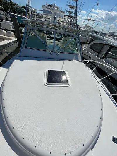  Yacht Photos Pics 2007 Henriques 35 Open boat docked in marina, sunny day.