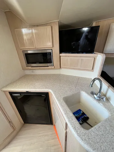  Yacht Photos Pics 2007 Henriques 35 Open boat interior with kitchenette, sink, microwave, and TV.