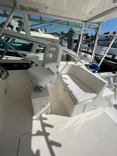  Yacht Photos Pics 2007 Henriques 35 Open boat interior with white seating and helm station.