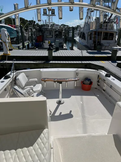  Yacht Photos Pics 2007 Henriques 35 Open boat docked, featuring spacious deck and seating area.