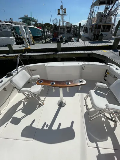  Yacht Photos Pics 2007 Henriques 35 Open boat with seating and table at marina.