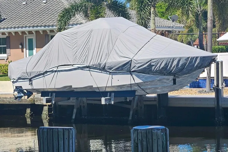  Yacht Photos Pics Covered 2017 Invincible 33 Open Fisherman boat docked near waterfront home.