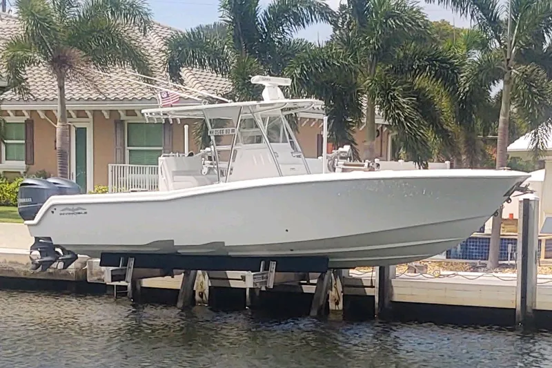  Yacht Photos Pics 2017 Invincible 33 Open Fisherman boat docked by waterfront home.
