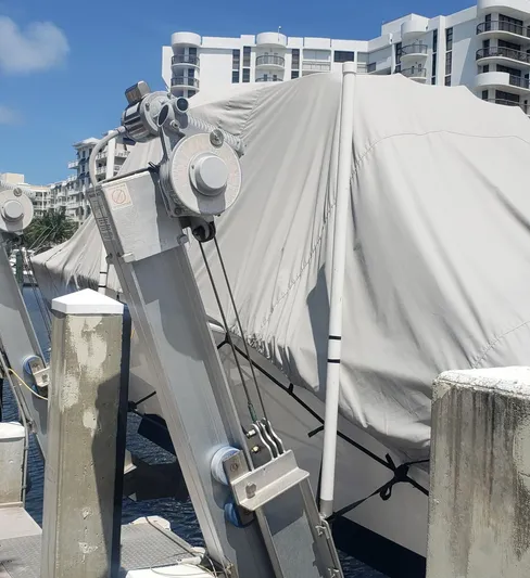 Yacht Photos Pics 2017 Invincible 33 Open Fisherman boat covered at a dock with buildings in the background.