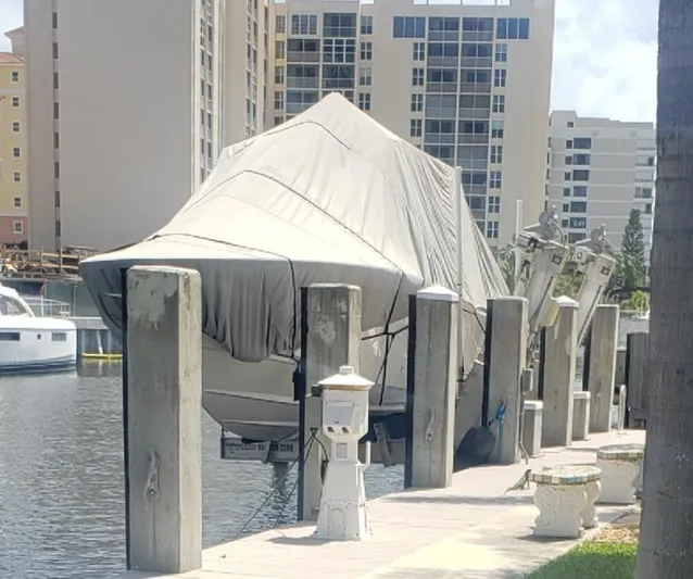  Yacht Photos Pics Covered 2017 Invincible 33 Open Fisherman boat docked near waterfront buildings.