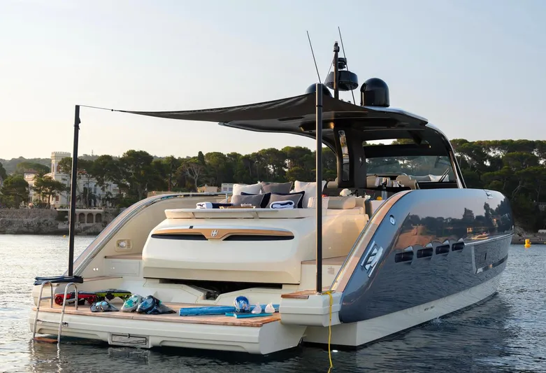  Yacht Photos Pics 2023 Invictus TT460 yacht with luxurious deck, anchored in serene waters.