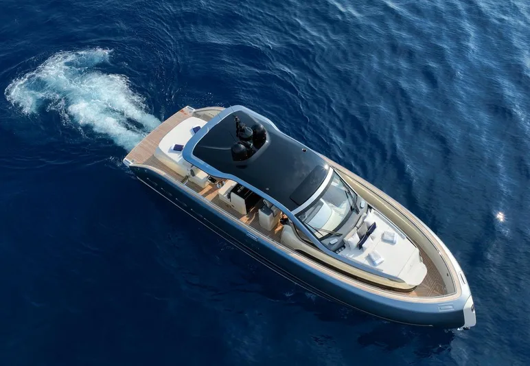  Yacht Photos Pics 2023 Invictus TT460 yacht cruising on open blue water, aerial view.
