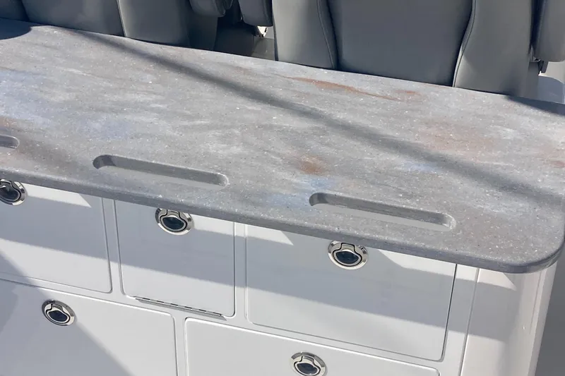 Storm Gray Yacht Photos Pics 2024 Regulator 30XO boat interior with sleek countertop and storage compartments.