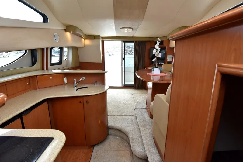 Pura Vida Yacht Photos Pics Interior of 2010 Silverton 38 Sedan Bridge yacht with modern kitchen and dining area.