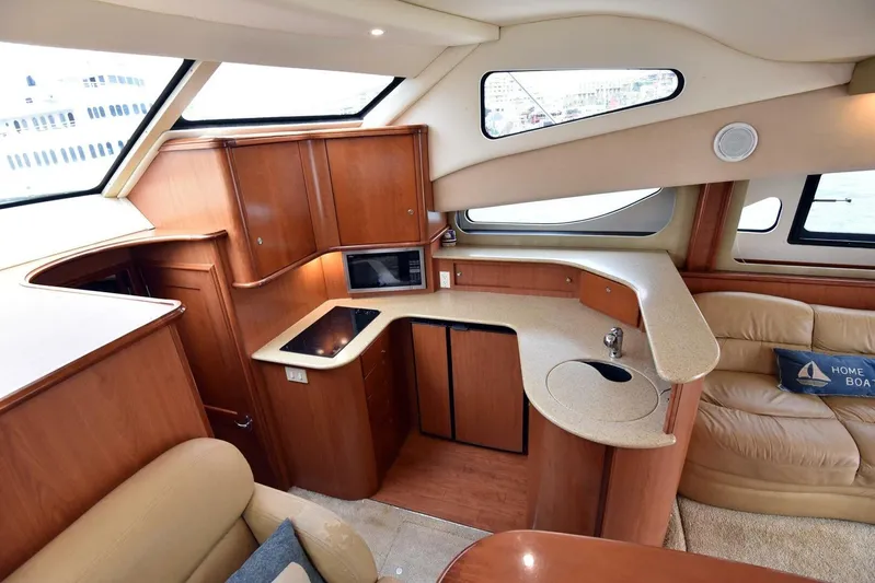 Pura Vida Yacht Photos Pics Interior of 2010 Silverton 38 Sedan Bridge yacht with modern kitchen and seating area.