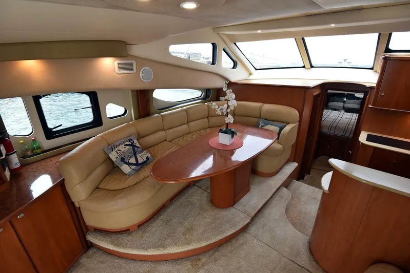 Pura Vida Yacht Photos Pics Luxurious interior of 2010 Silverton 38 Sedan Bridge yacht with elegant seating and decor.