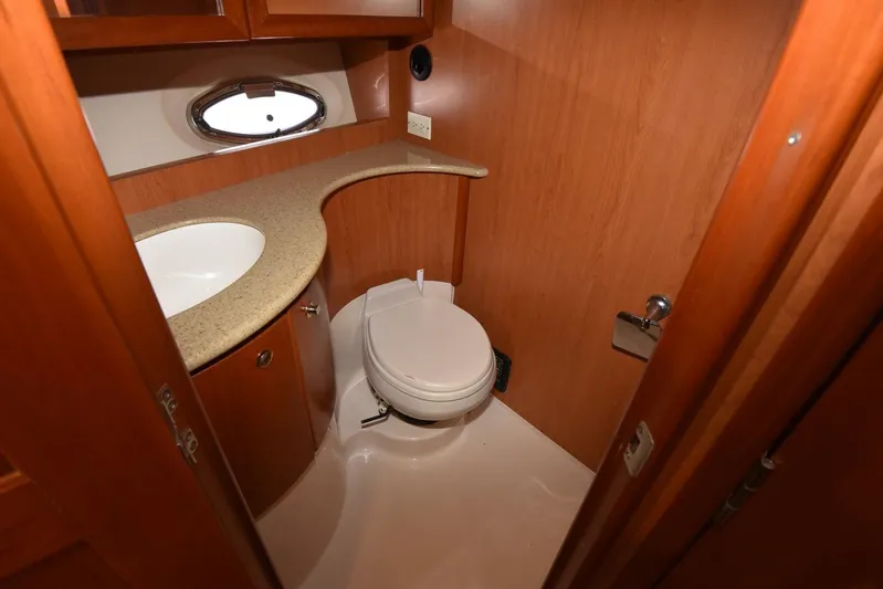 Pura Vida Yacht Photos Pics Luxurious bathroom in 2010 Silverton 38 Sedan Bridge yacht with wood cabinetry and modern fixtures.