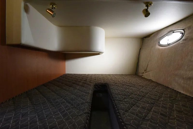 Pura Vida Yacht Photos Pics 2010 Silverton 38 Sedan Bridge cabin interior with quilted bedding and porthole window.