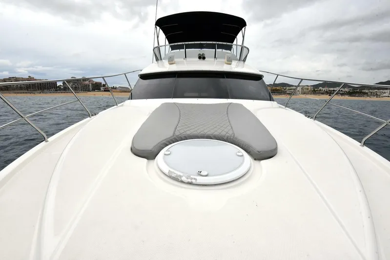 Pura Vida Yacht Photos Pics 2010 Silverton 38 Sedan Bridge yacht on open water, featuring spacious deck and sleek design.