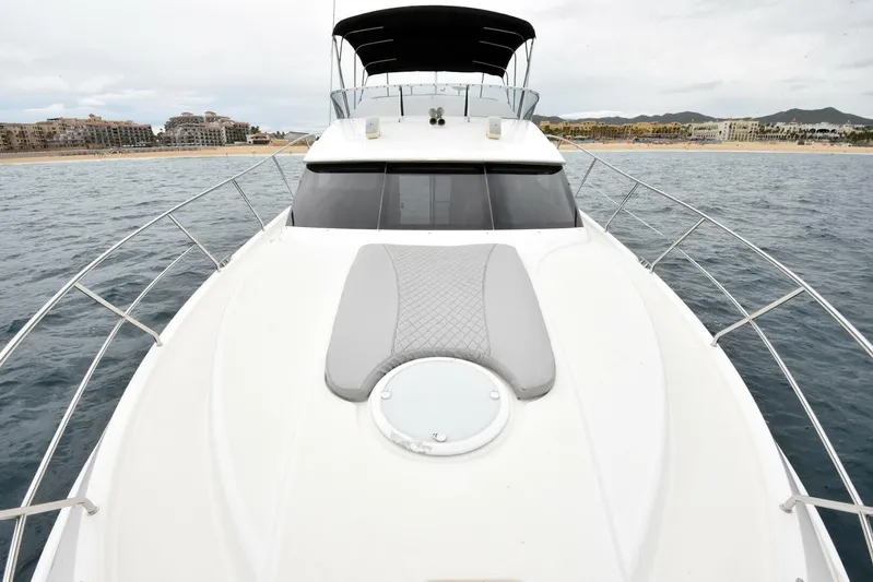 Pura Vida Yacht Photos Pics 2010 Silverton 38 Sedan Bridge yacht on open water, featuring spacious deck and sleek design.