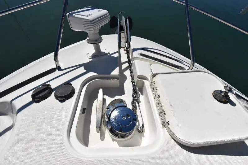 Pura Vida Yacht Photos Pics 2010 Silverton 38 Sedan Bridge anchor system on deck, featuring a windlass and chain.