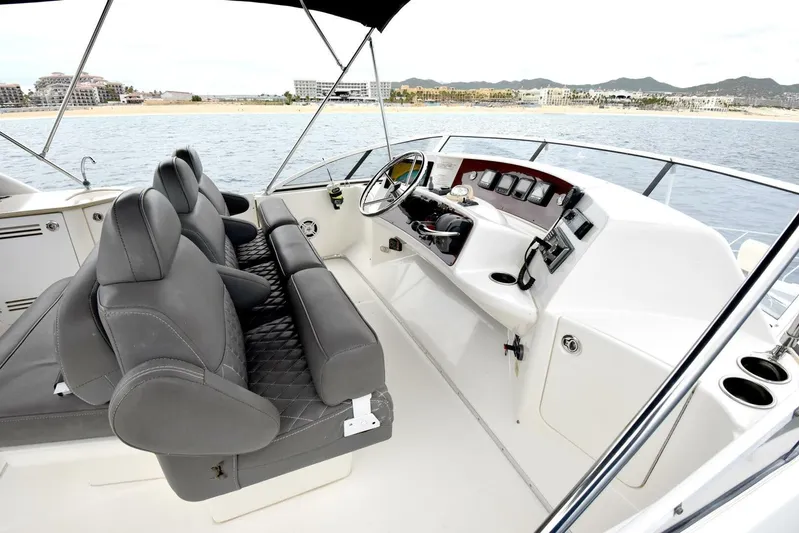 Pura Vida Yacht Photos Pics 2010 Silverton 38 Sedan Bridge yacht helm with leather seating and ocean view.