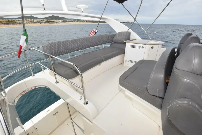 Pura Vida Yacht Photos Pics 2010 Silverton 38 Sedan Bridge yacht with spacious seating, cruising on open water.