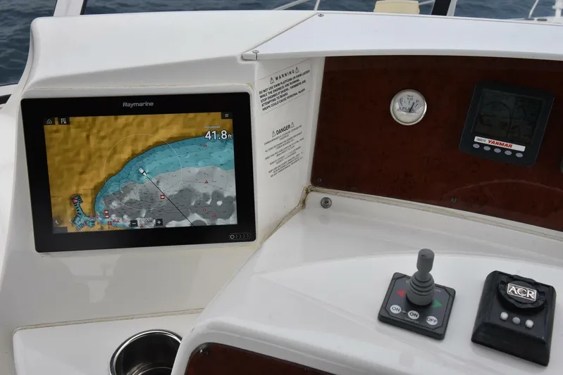 Pura Vida Yacht Photos Pics Control panel of 2010 Silverton 38 Sedan Bridge with navigation display and controls.