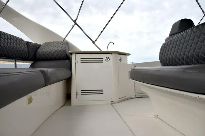 Pura Vida Yacht Photos Pics 2010 Silverton 38 Sedan Bridge interior with cushioned seating and storage cabinet.