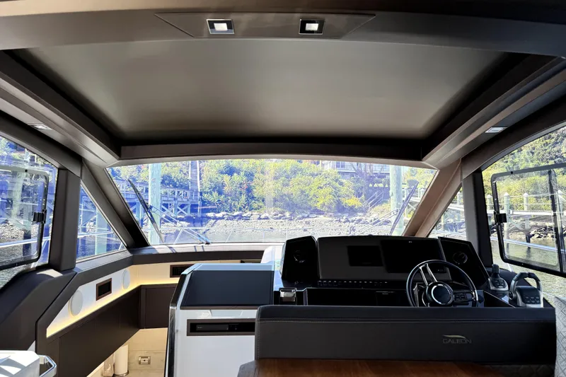  Yacht Photos Pics Interior view of 2023 Galeon 425 HTS yacht cockpit with modern design and panoramic windows.