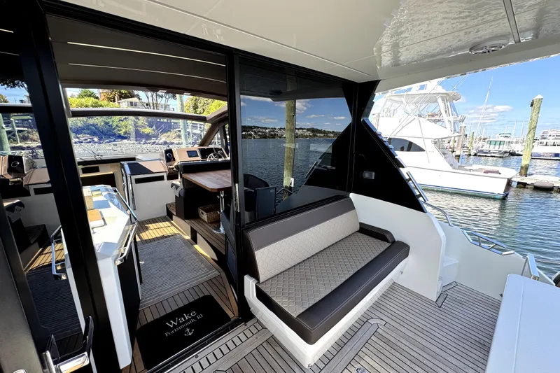  Yacht Photos Pics Luxurious 2023 Galeon 425 HTS yacht interior with elegant seating and scenic marina view.