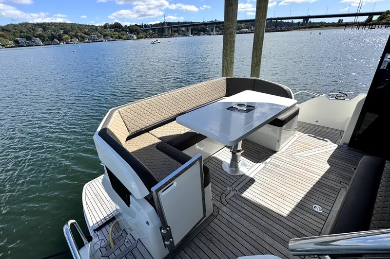  Yacht Photos Pics Luxurious 2023 Galeon 425 HTS yacht deck with seating and table, overlooking serene waters.