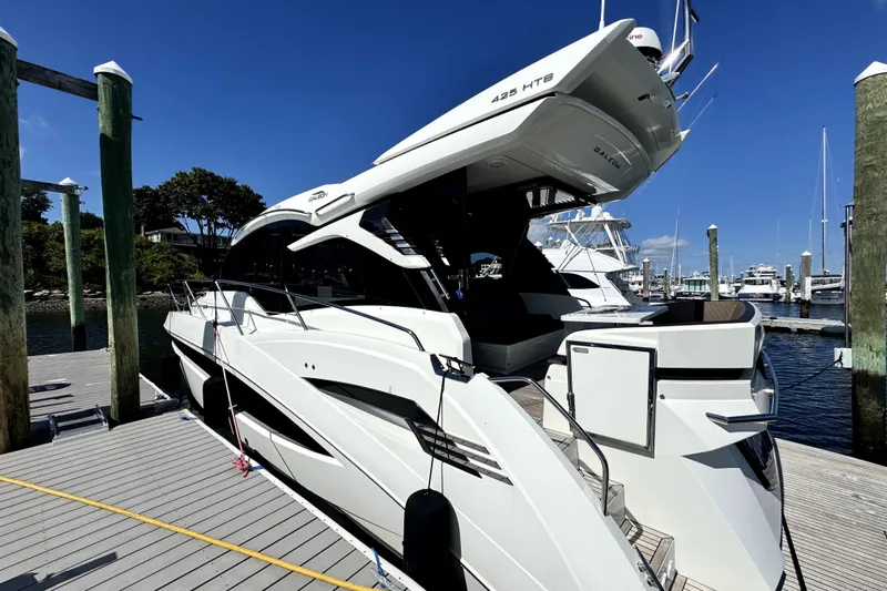  Yacht Photos Pics 2023 Galeon 425 HTS yacht docked at marina under clear blue sky.