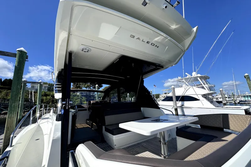  Yacht Photos Pics 2023 Galeon 425 HTS yacht with sleek design docked at marina under clear blue sky.